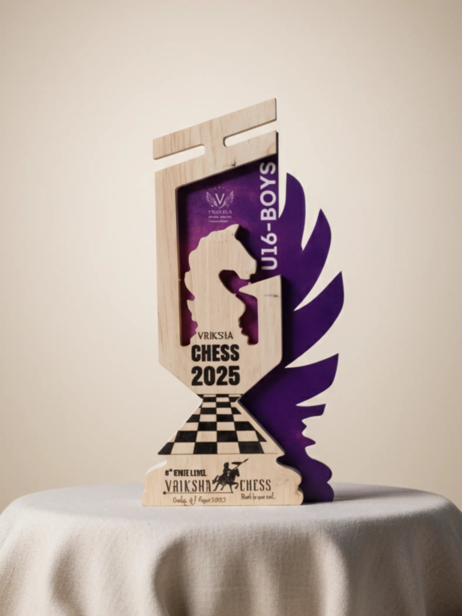 Wooden chess trophy with purple and black design on a beige background