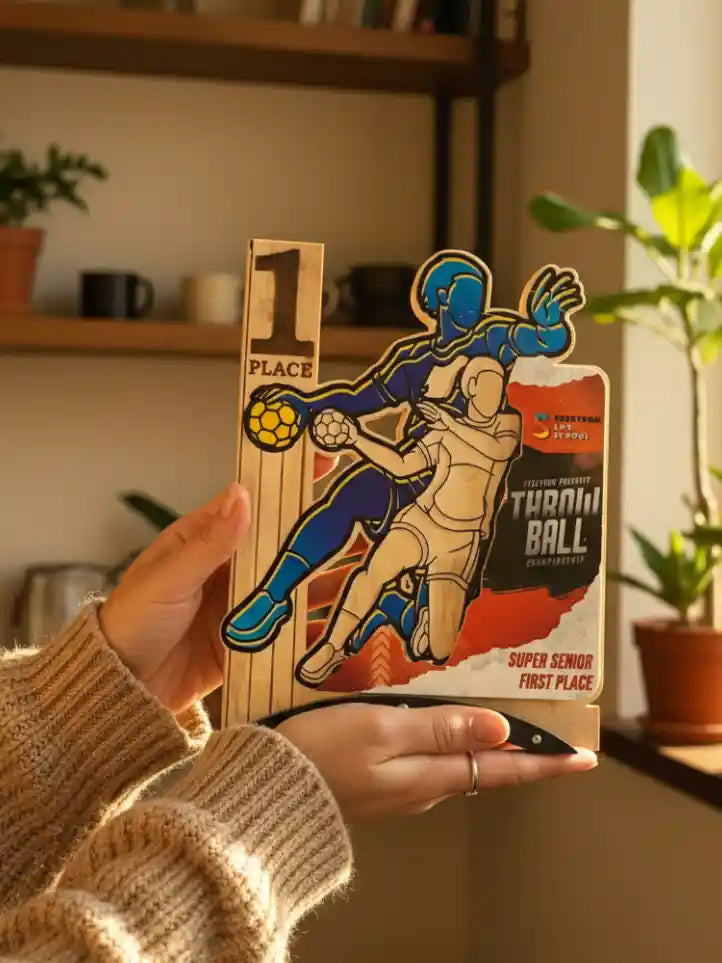 Hand holding a wooden trophy with sports design in a home setting