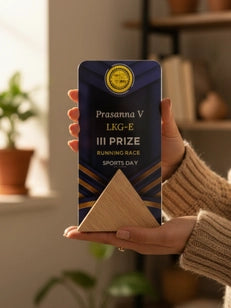 Person holding a Prasanna V Lax-E III Prize sports day award in a home setting.