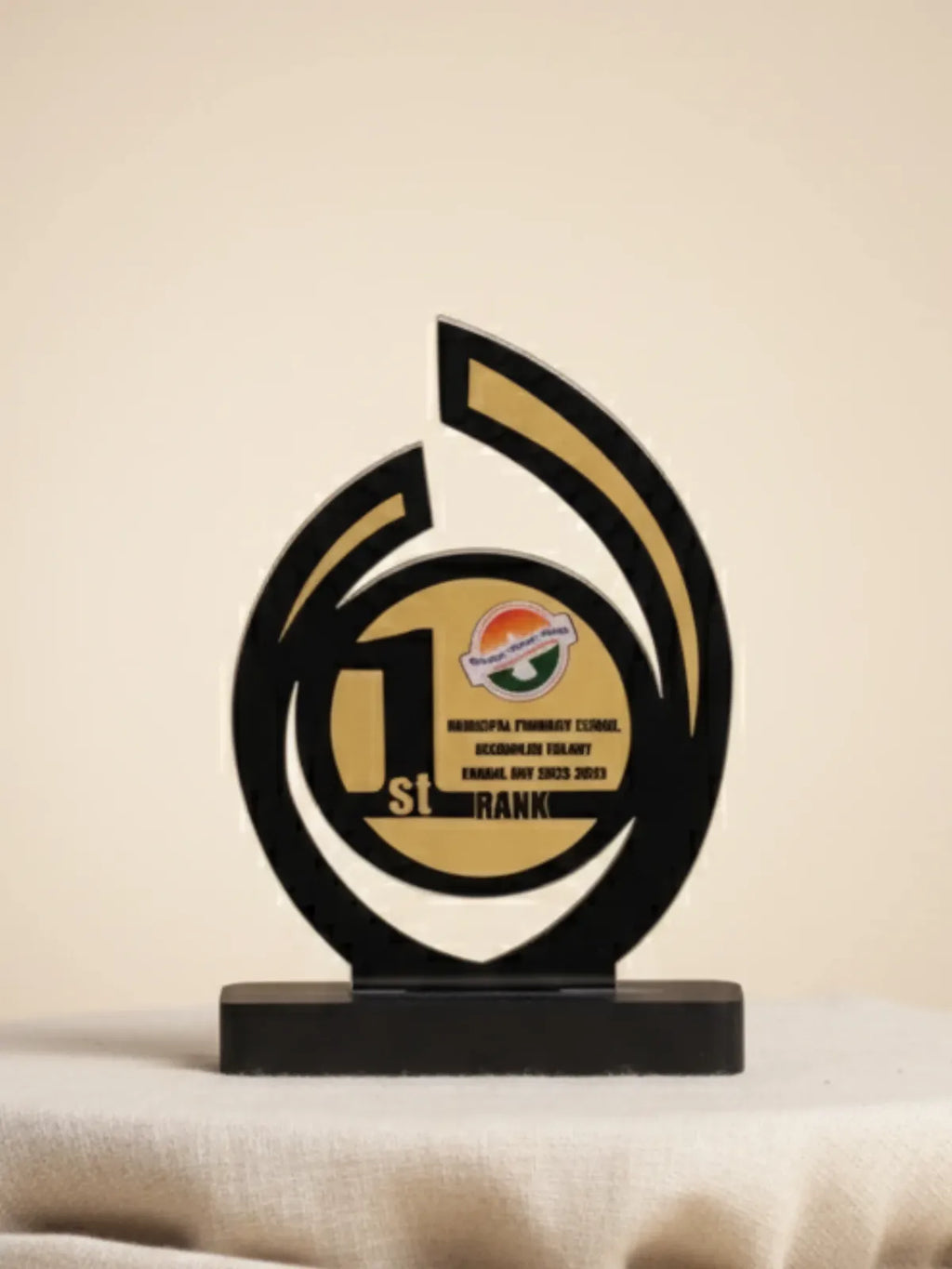Decorative award with black and gold design on a beige background