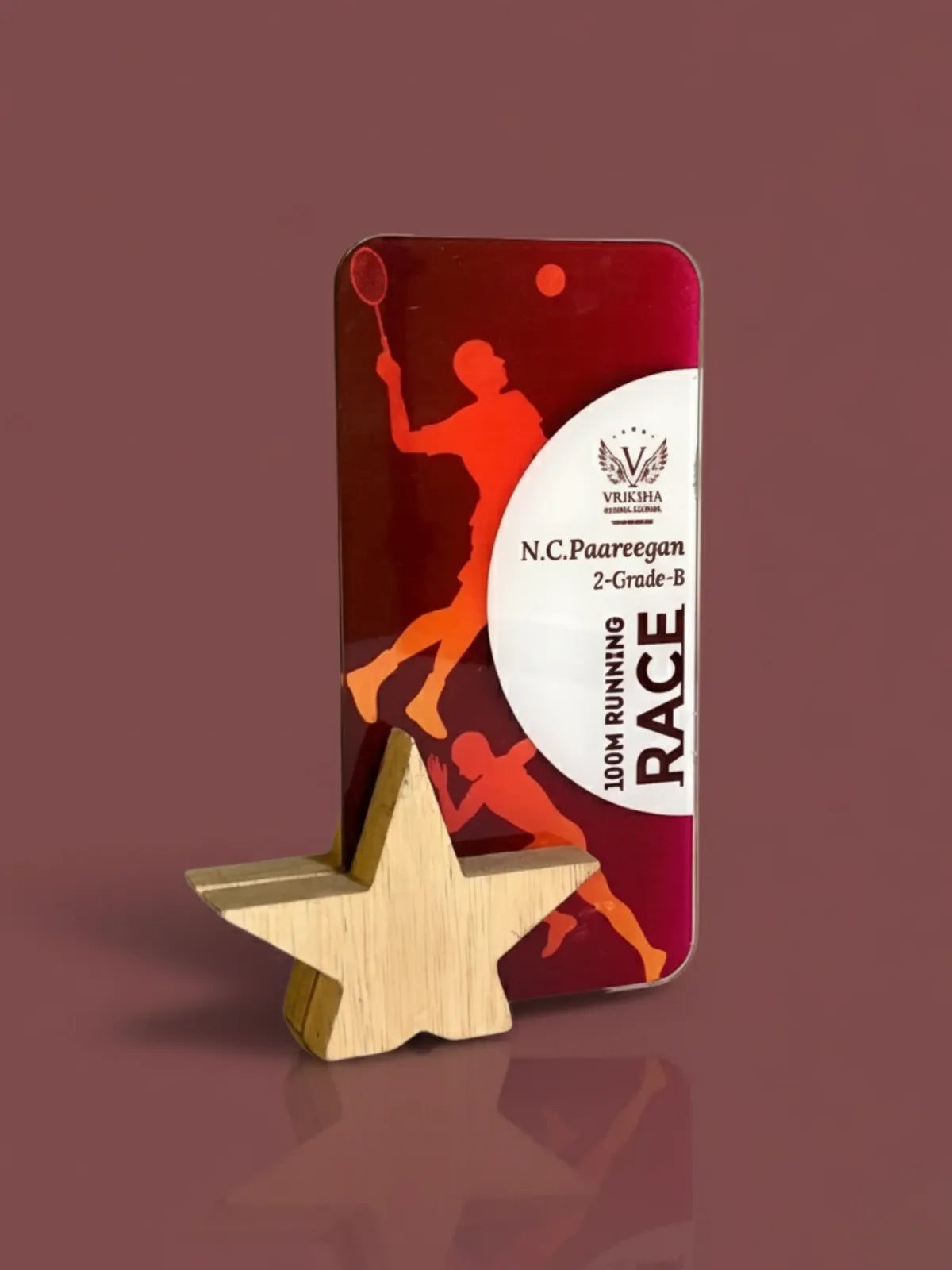 Trophy with star base and red and white packaging on a brown background