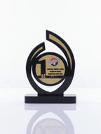 Decorative trophy with a black and gold design on a white background