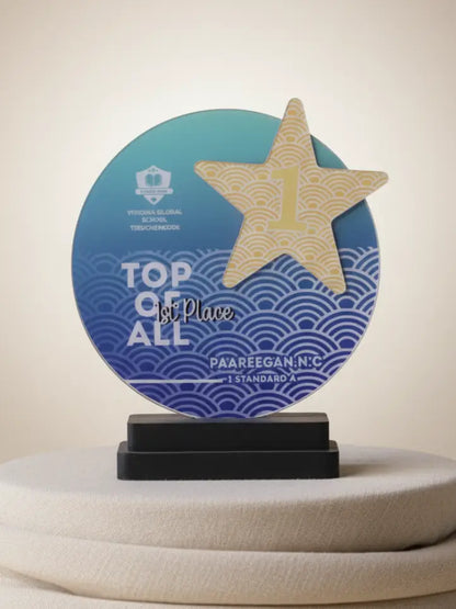 Awards trophy with a star on a blue circular base, featuring text 'Top of All 1st Place' and 'Paareegan N.C'.