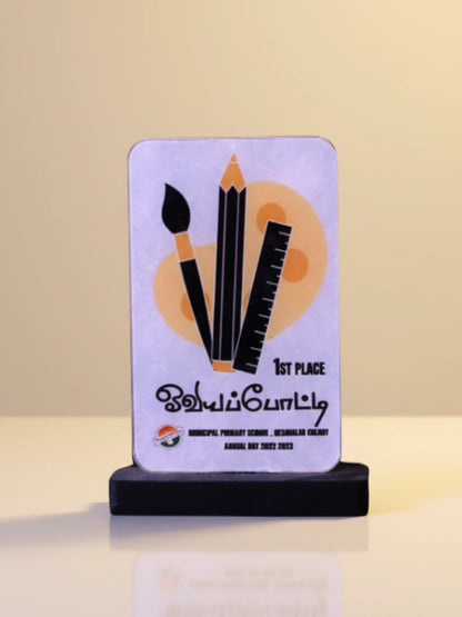 Award plaque with artistic design on a stand against a beige background