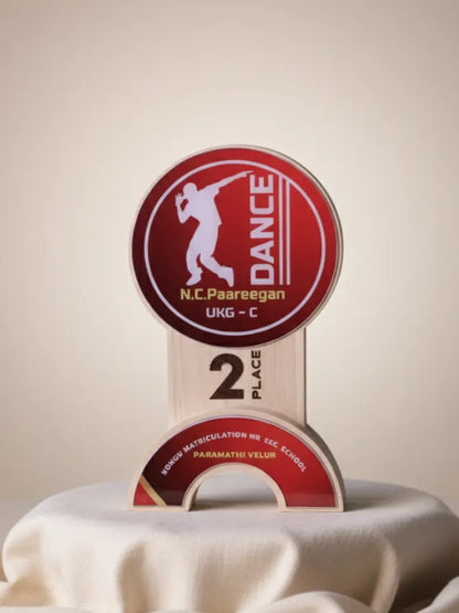 Dance competition trophy with 'N.C. Paareegan' branding on a beige background