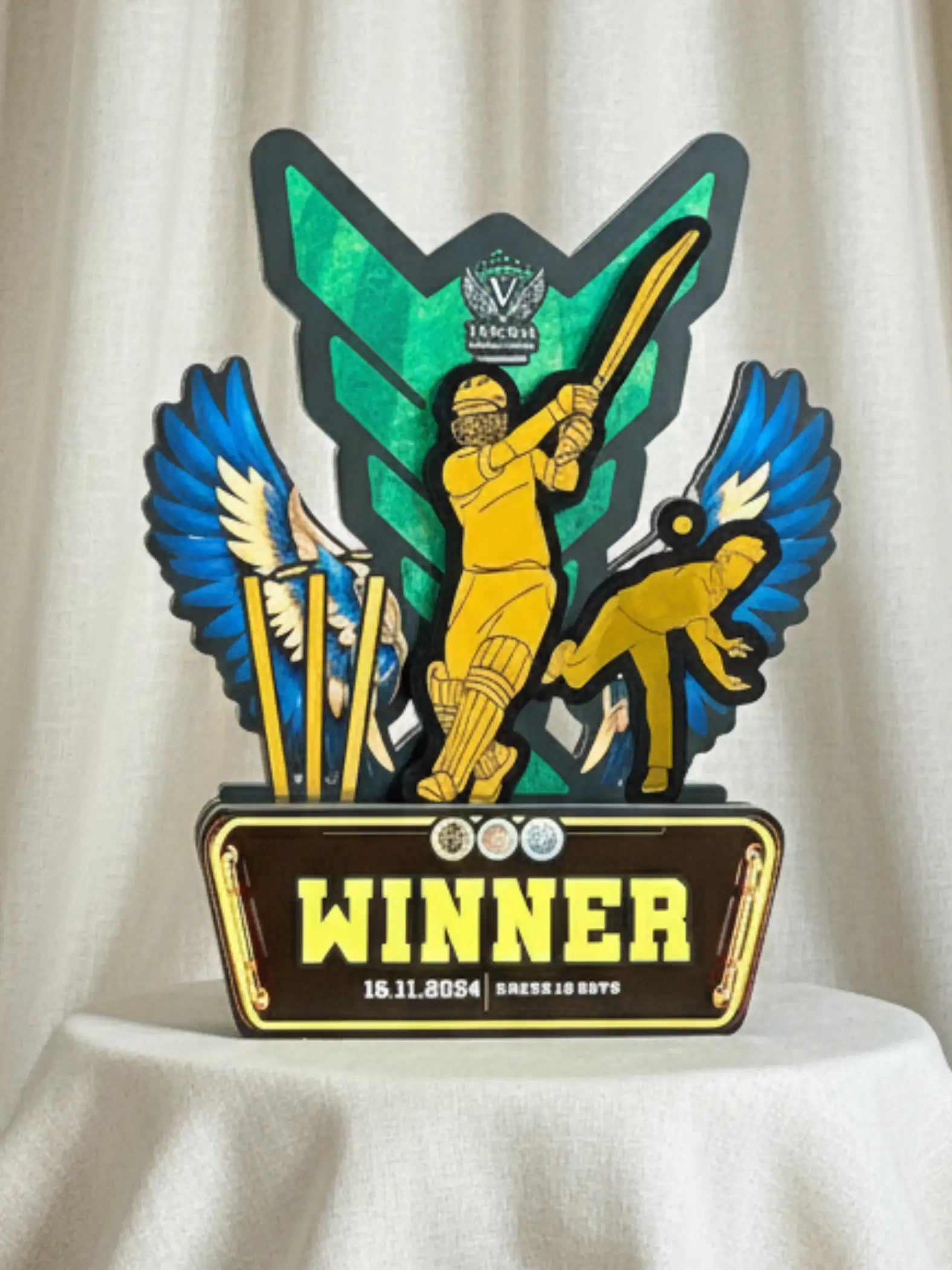 Decorative trophy with a cricket theme on a white background