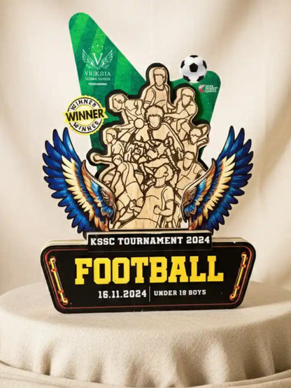 Wooden trophy with decorative elements and text for KSSC Tournament 2024 Football event.