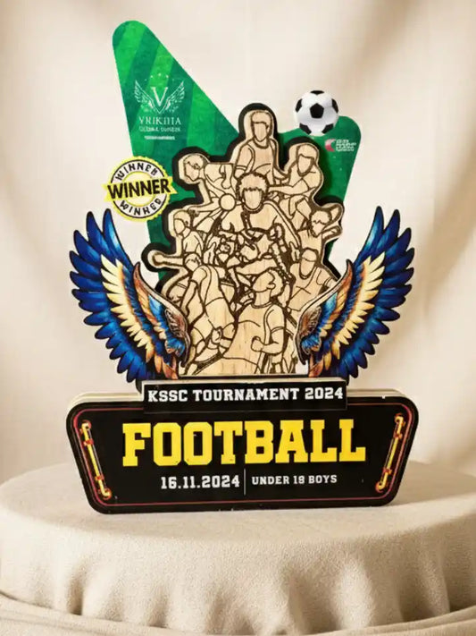 Wooden trophy with decorative elements and text for KSSC Tournament 2024 Football event.