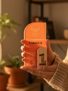 Hand holding a container of orange butter with a blurred indoor background