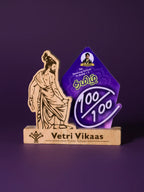 Decorative award with a figure and 'Vetri Vikaas' branding on a purple background