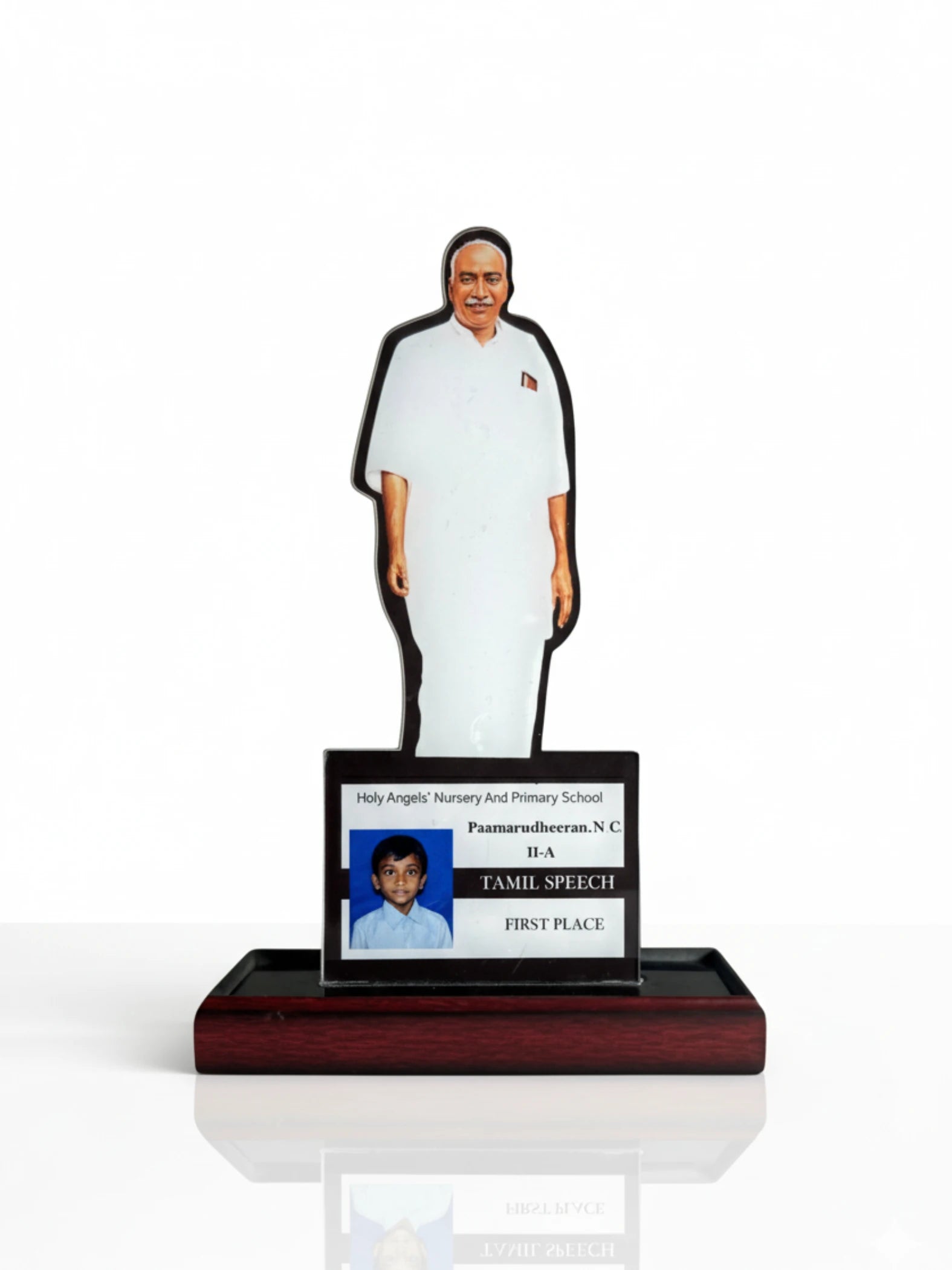 Figurine of a person with a nameplate on a white background