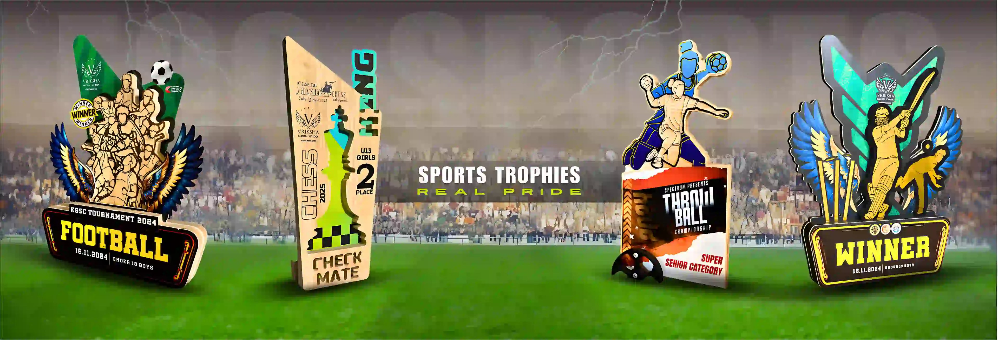 Collection of sports trophies with different designs on a grassy field background.
