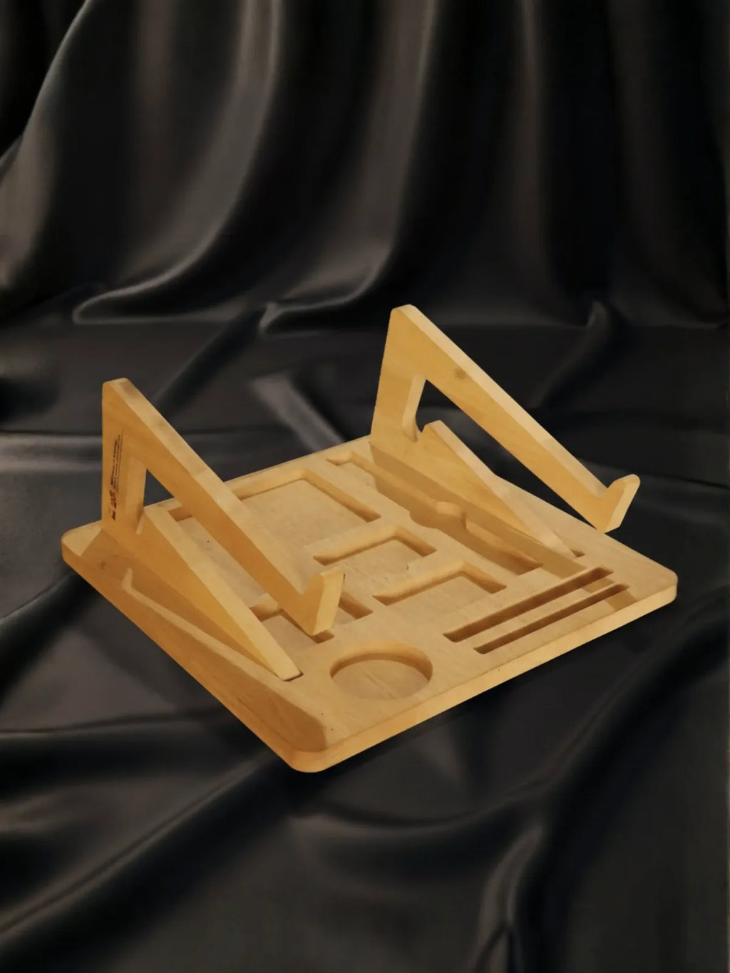 Wooden book stand on a black satin background