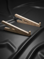 Two wooden car ramps on a black textured surface