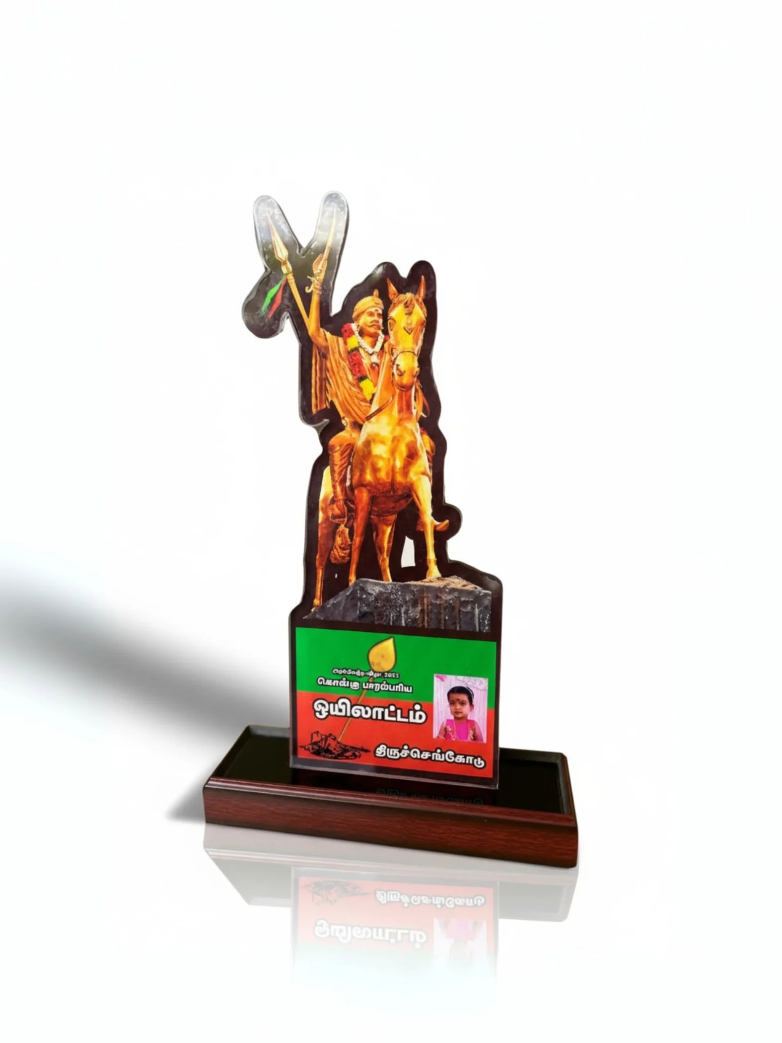 Decorative item with a figure on a horse and a green label on a white background