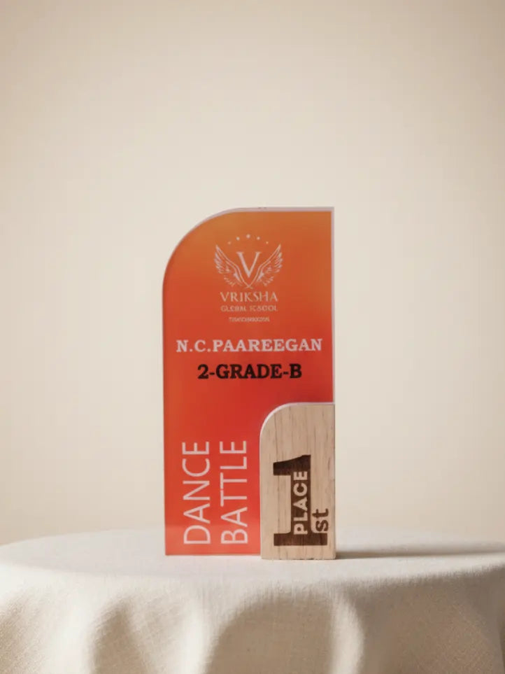 Orange award with text and a wooden plaque on a white surface