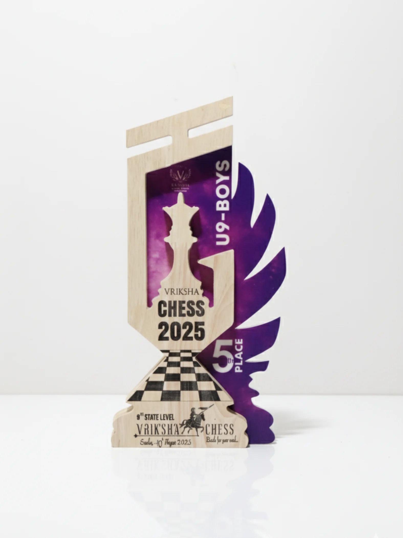 Chess queen trophy displayed in tournament award ceremony setting