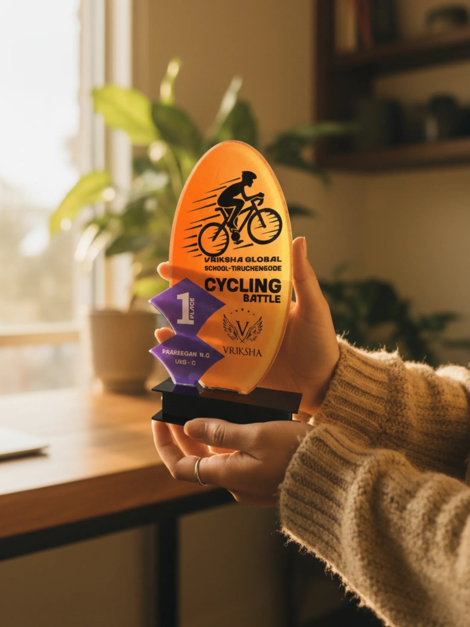 Close-up view of cycling trophy showing detailed wooden craftsmanship and acrylic elements