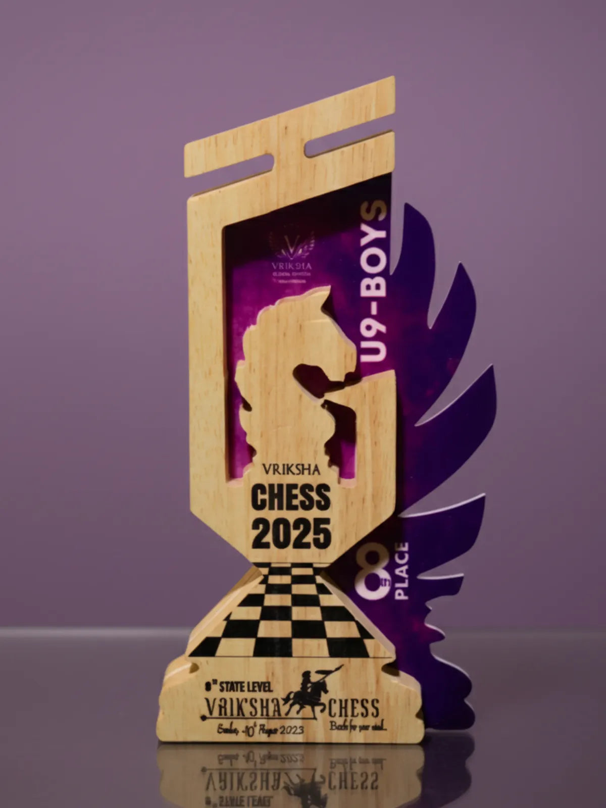 Wooden chess trophy with purple accents on a reflective surface against a purple background