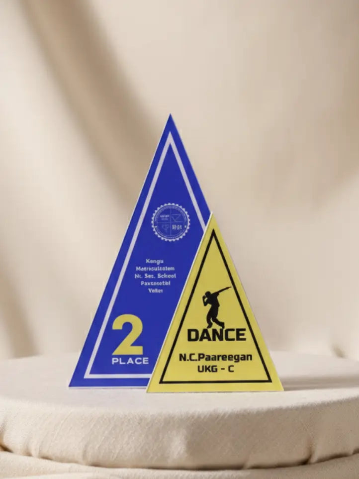 Two triangular awards on a beige fabric background