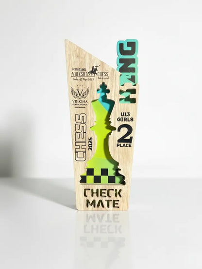 Wooden chess-themed trophy with green piece on a white background