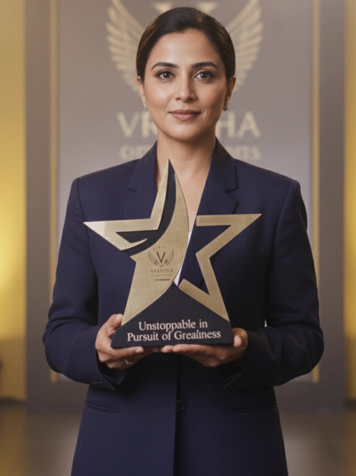 Woman holding an award with a star design, standing against a blurred background with 'Vishwa' branding.