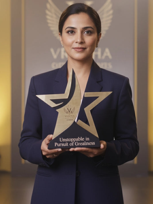 Woman holding an award with a star design, standing against a blurred background with 'Vishwa' branding.