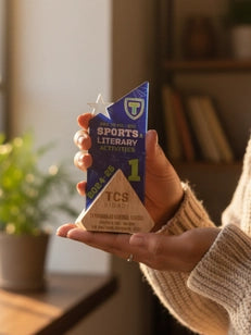 Person holding a sports literacy book in a cozy indoor setting
