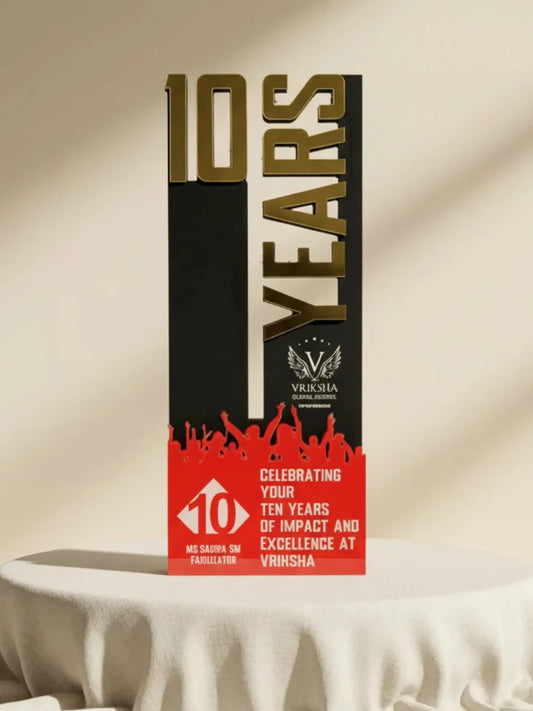 Trophy celebrating 10 years of impact and excellence at Vriksha on a beige background