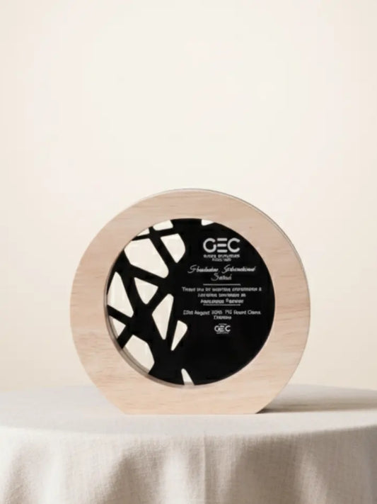Round wooden award with black center and 'GEC' branding on a beige background