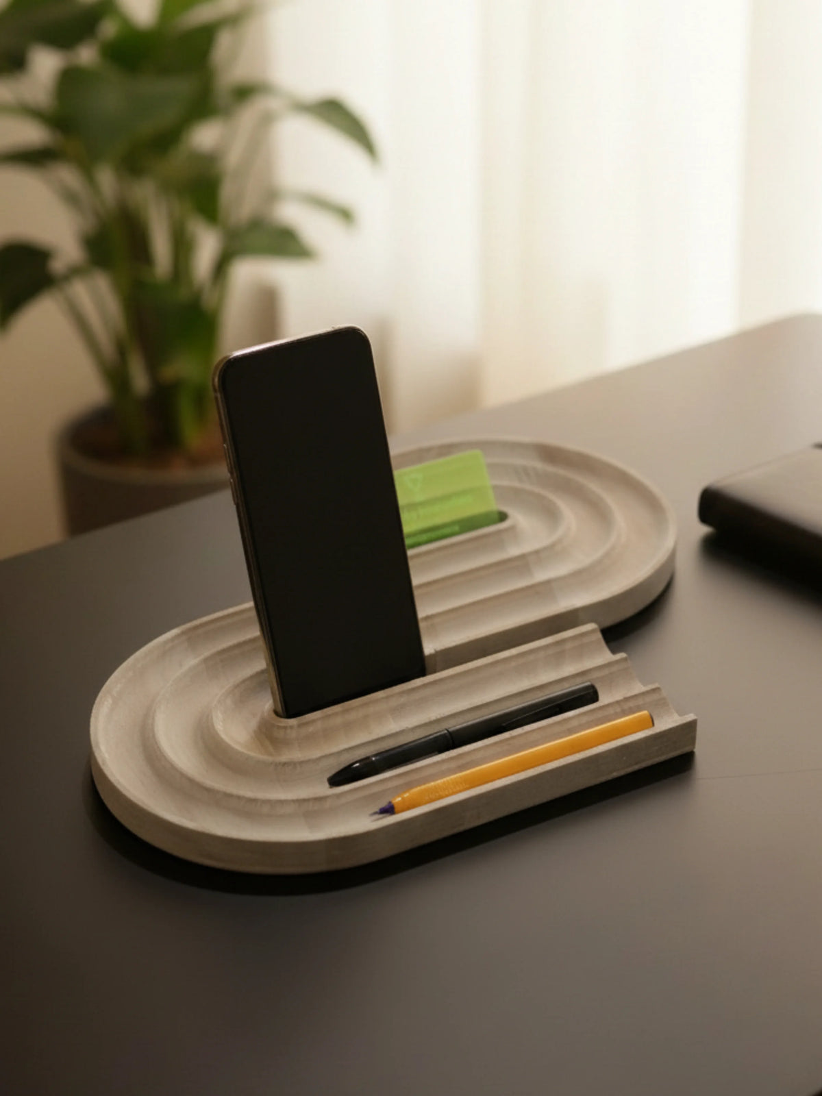 Customized pen and mobile phone stand displaying multiple pens and device holder functionality
