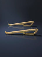 Two wooden ski runners on a reflective dark surface