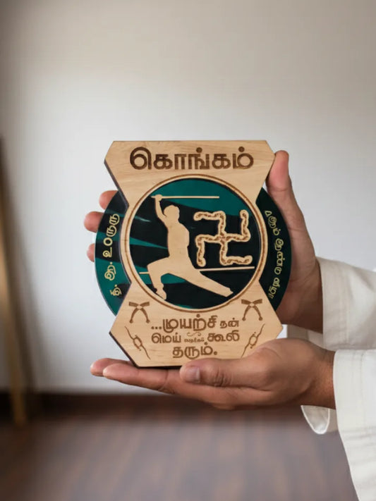 Hand holding a wooden plaque with engraved design and text