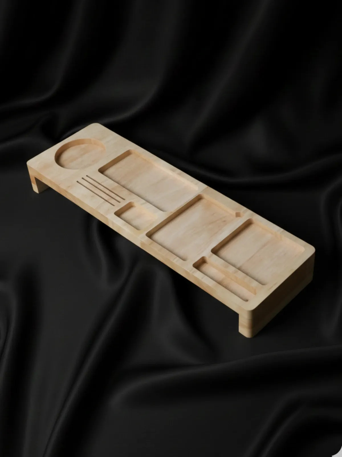 Wooden tray with compartments on a black fabric background