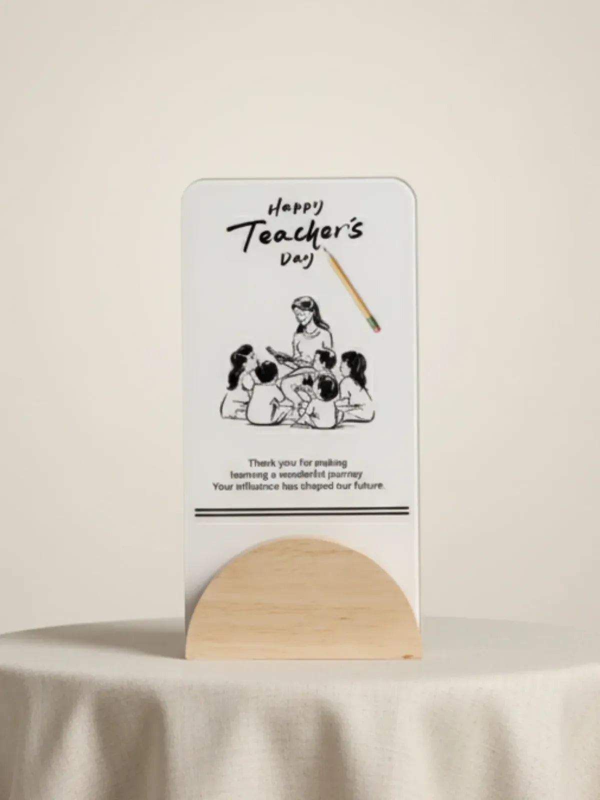 Card with illustration of children and teacher, text 'Happy Teacher's Day', on a stand against a beige background.