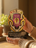 Person holding a district-level award with a blurred background
