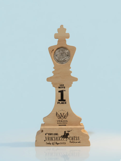 Wooden chess piece trophy with engraved text on a light blue background