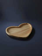 Heart-shaped wooden tray on a dark blue background