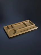 Wooden tray with geometric compartments on a gray blue satin background