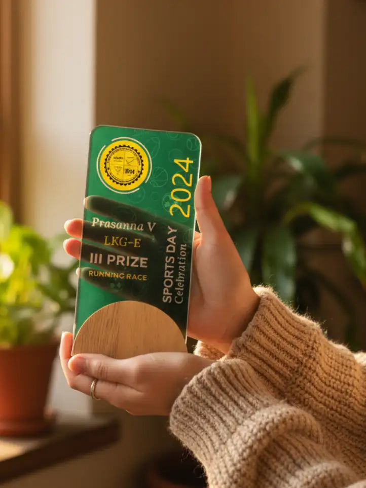 Person holding a green card with a wooden disc, surrounded by plants indoors.