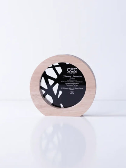 Round wooden product with black label on a white background