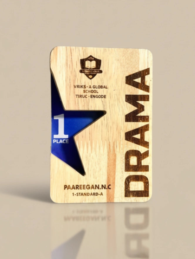 Wooden plaque with 'Drama' and '1st Place' text on a beige background