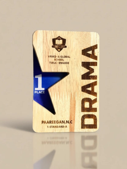 Wooden plaque with 'Drama' and '1st Place' text on a beige background