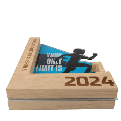 Wooden block with 'Your Only Limit Is 2024' message and silhouette of a runner, branded 'Vivekananda Global School'.