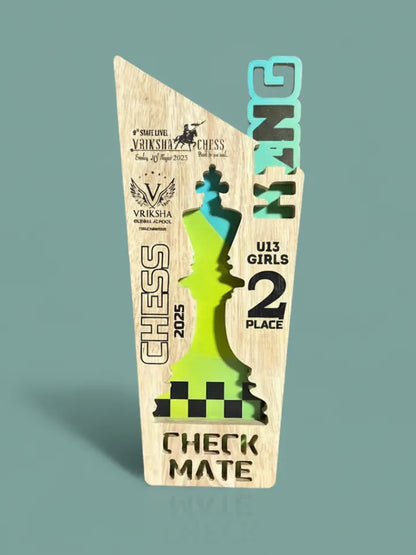 Wooden chess-themed trophy with engraved text on a teal background