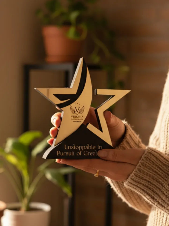 Hand holding a star-shaped award with 'Unstoppable in Pursuit of Great' text, blurred indoor background