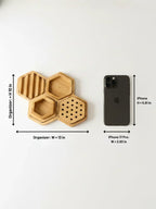 Wooden hexagonal organizer with dimensions labeled next to an iPhone on a white background