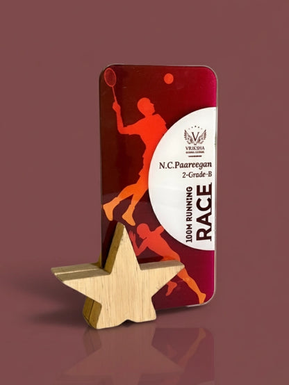 Decorative metal plaque with running race design and wooden star on a brown background