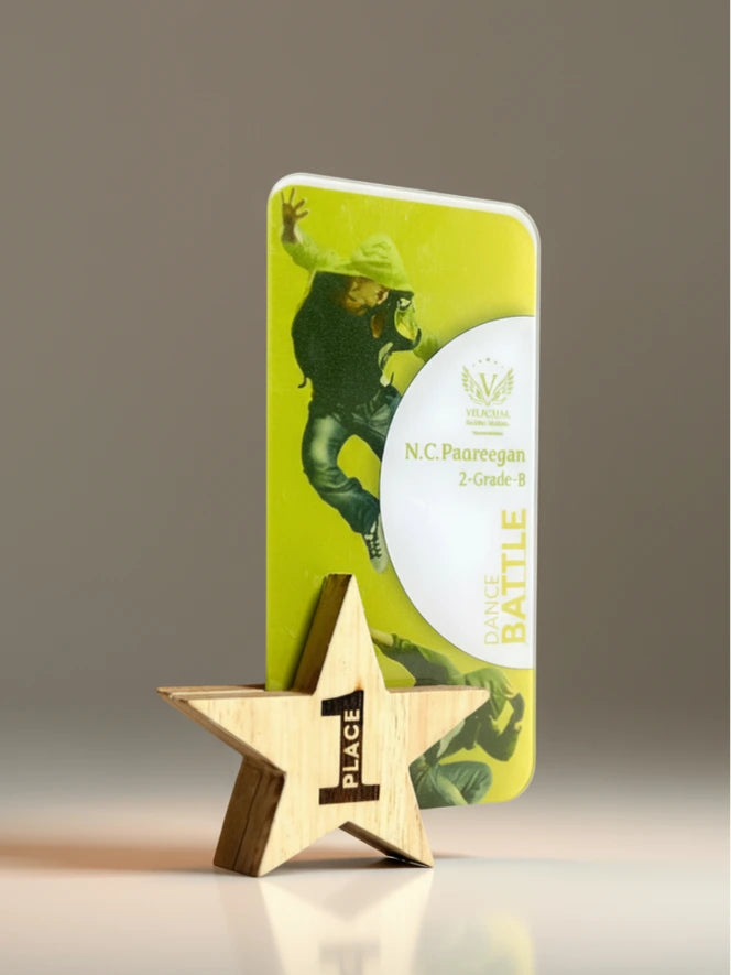 Gold star trophy with '1st Place' on a reflective surface, next to a green card with a dancer on a gray background