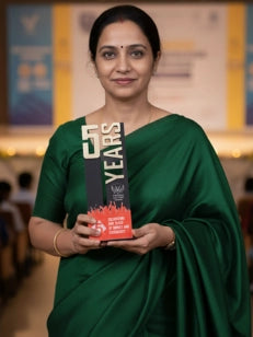 Woman in a green saree holding an award with text
